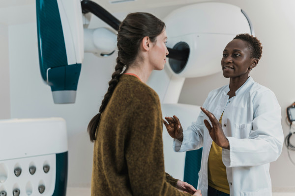 A doctor sitting down and talking a patient through their diagnosis in plain terms