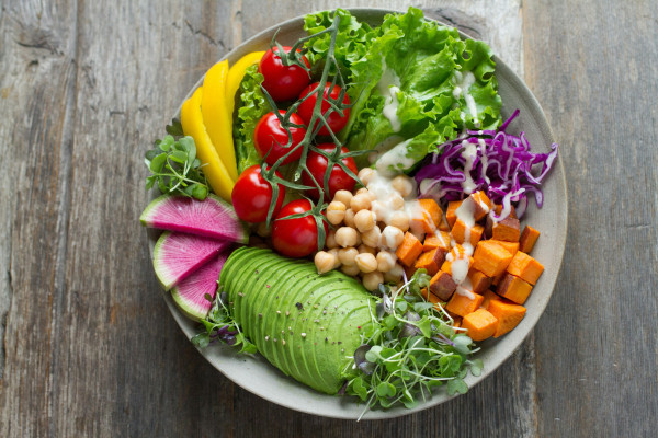 A colourful bowl of mixed vegetable salad featuring a variety of fresh produce.