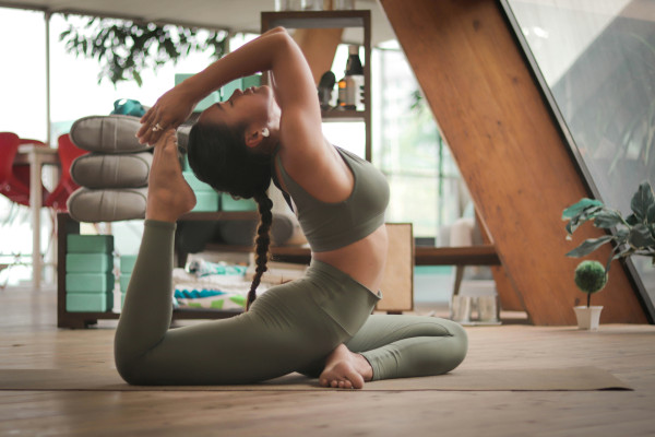 A woman holding a yoga pose, demonstrating balance and flexibility.
