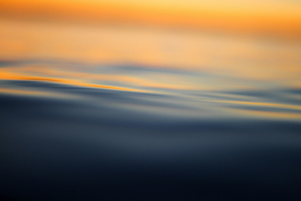 Calm, still water at sunset, reflecting the settled state the body reaches once a stress response has passed
