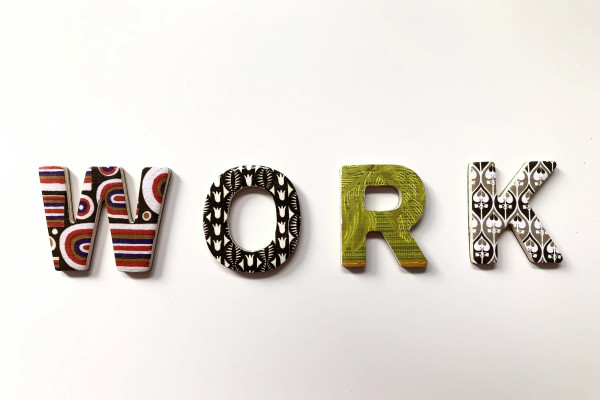 Freestanding letters spelling the word "work" on a surface.