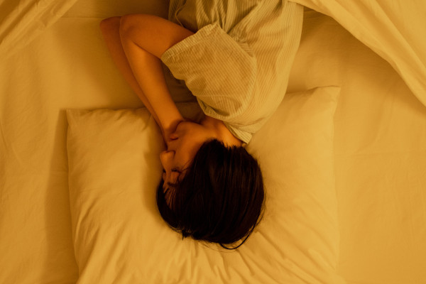 A person sleeping peacefully in bed, showing signs of relaxation