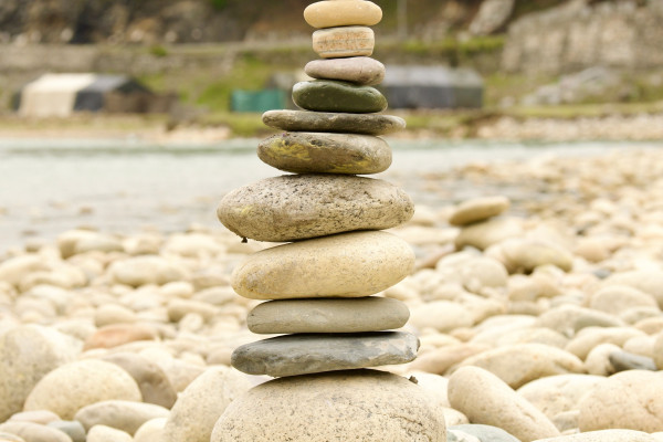 Stack of smooth stones balanced on a pebble beach