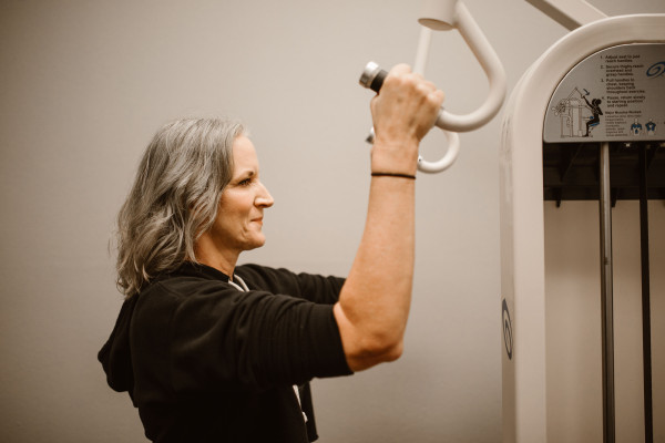 Older woman using gym equipment to build strength and improve balance