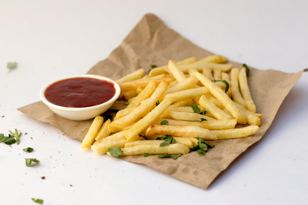 A portion of fries served with ketchup.