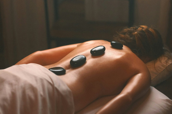 Hot stones placed along a client's back during a soft tissue treatment session